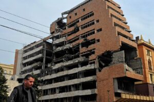 A pedestrian walks past the bomb-damaged building of the former Yugoslavia federal military headquarters in Belgrade, Serbia, March 24, 2010. (AFP Photo)