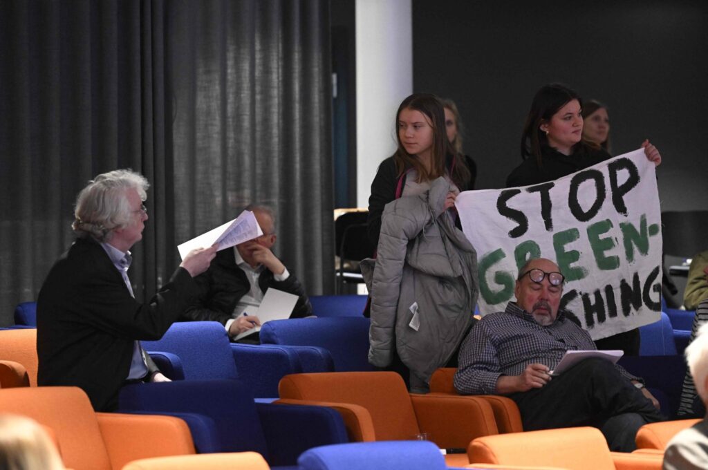 Swedish climate activist Greta Thunberg and activists from the Fridays For Future movement protest with a banner reading "SAS stop greenwashing," Stockholm, Sweden, March 18, 2024. (AFP Photo)