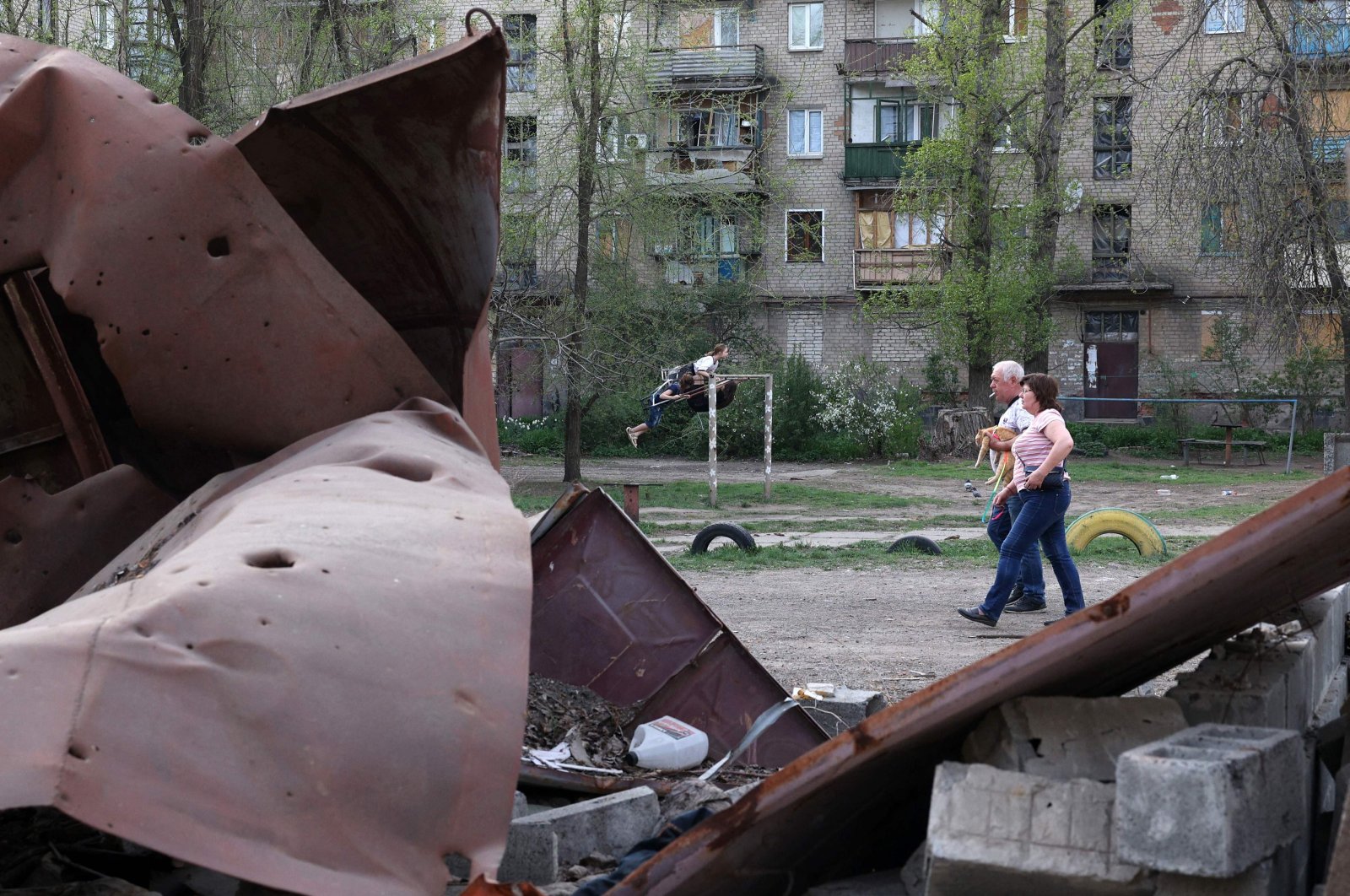 Children play in front of houses amid the Russian invasion in the town of Kostyantynivka, Donetsk region, Ukraine, April 11, 2024. (AFP Photo)