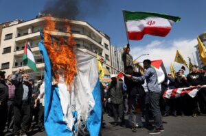 Iranians burn an Israeli flag during a rally marking Quds Day and the funeral of members of the Islamic Revolutionary Guard Corps who were killed in a suspected Israeli airstrike on the Iranian Embassy complex in the Syrian capital Damascus, Tehran, Iran, April 5, 2024. (Reuters Photo)