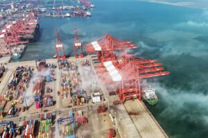 An aerial view shows gantry cranes and shipping containers at a port in Lianyungang, in eastern China's Jiangsu province, April 12, 2024. (AFP Photo)