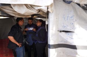 Palestinian journalist Hind Khoudary (R) and Anadolu Agency (AA) photographer Ali Jadallah speak with a colleague inside a tent at a makeshift camp for displaced people in front of the Al-Aqsa Martyrs Hospital, Deir al-Balah, Gaza Strip, Palestine, March 31, 2024. (AFP Photo)
