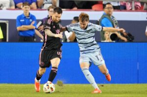 Inter Miami's Lionel Messi (L) and Sporting Kansas City's Jake Davis fight for the ball during the first half at GEHA Field at Arrowhead Stadium, Kansas City, Kansas, U.S., April 13, 2024. (Reuters Photo)