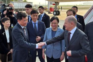 German Chancellor Olaf Scholz shakes hands with Chinese Ambassador to Germany Wu Ken next to Chongqing Vice Mayor Zhang Guozhi upon arriving at the airport in Chongqing, China, April 14, 2024. (Reuters Photo)