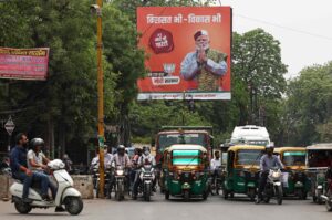 Vehicles move past an election campaign hoarding of the Bharatiya Janata Party (BJP) featuring their leader and India's Prime Minister Narendra Modi, Varanasi, India, April 13, 2024. (AFP Photo)