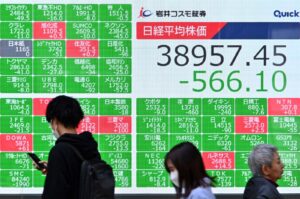 Pedestrians walk past an electronic board showing a share price of the Nikkei index of the Tokyo Stock Exchange, Tokyo, Japan, April 15, 2024. (AFP Photo)