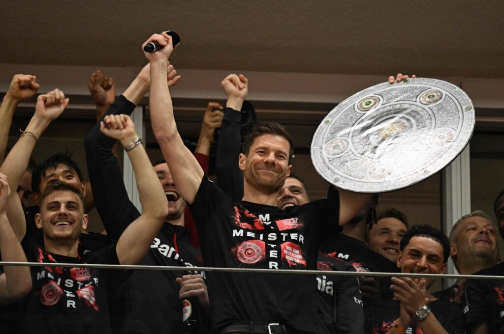Bayer Leverkusen's Xabi Alonso celebrates with a mock-up of the Bundesliga trophy with his players after the German first division Bundesliga football match against Werder Bremen, Leverkusen, Germany, April 14, 2024. (AFP Photo)