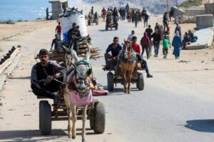People ride animal-drawn carts as Palestinians, who were displaced by Israel's military offensive on south Gaza, make their way attempting to return to their homes in north Gaza through an Israeli checkpoint, Gaza Strip, Palestine, April 15, 2024. (Reuters Photo)