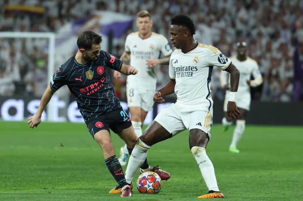 Real Madrid's Vinicius Jr. (R) in action against Manchester City's Bernardo Silva (L) during the UEFA Champions League quarterfinals first leg match, Madrid, Spain, April 9, 2024. (EPA Photo)