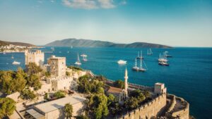 The Castle of St. Peter and the picturesque Bodrum Marina adorned with sailing boats and yachts, Bodrum, Türkiye. (Shutterstock Photo)