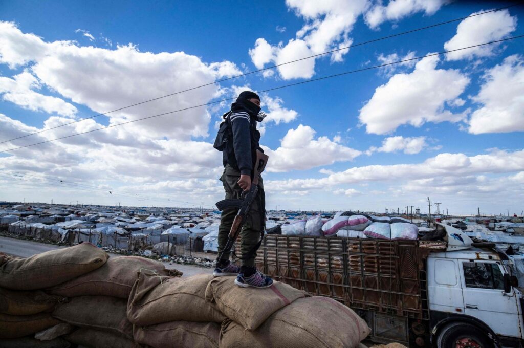 A YPG/PKK terrorist watches the al-Hol camp in Hassakeh, Syria, March 18, 2021. (AFP Photo)