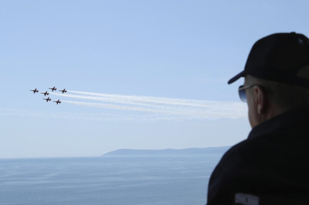 President Recep Tayyip Erdoğan watches jet fighters fly past during the final day of military exercises in the Aegean Sea, near Izmir, Türkiye, June 9, 2022. (AP Photo)