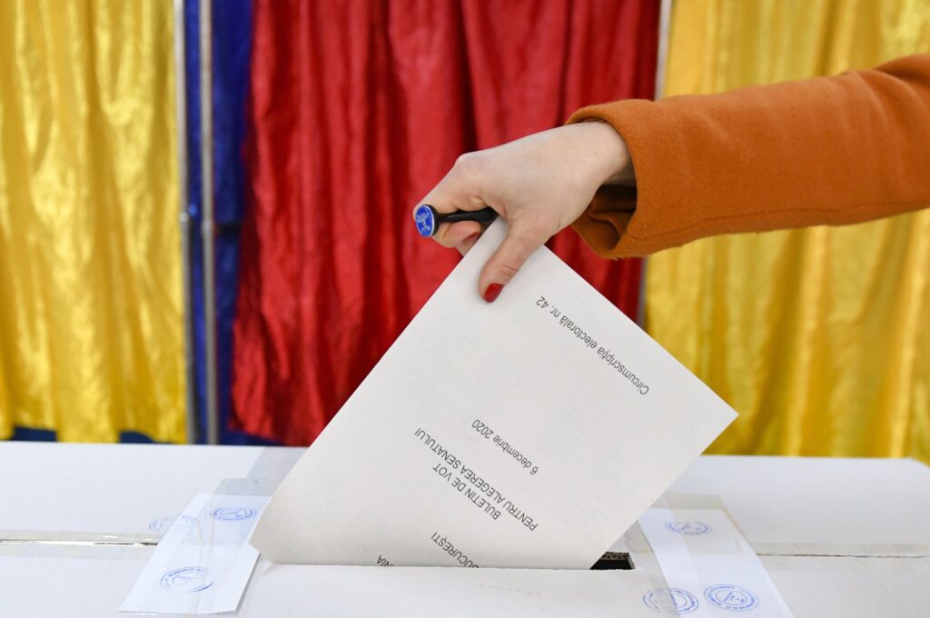 A woman casts her vote in Romania's legislative election, in Bucharest, Romania, Dec. 6, 2020. (AP File Photo)