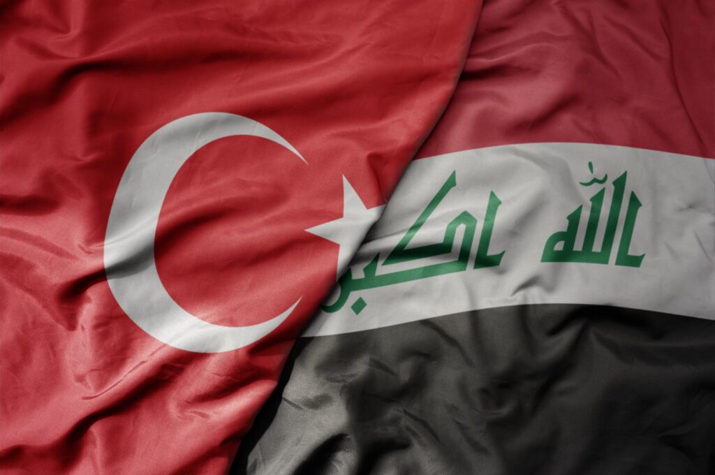 The national flags of Türkiye (L) and Iraq (Shutterstock)