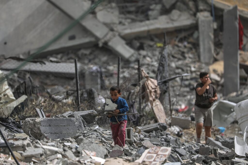 Palestinian children walk among the rubble after returning to Al Nusairat refugee camp following the Israeli army's withdrawal from the area, southern Gaza Strip, April 18, 2024. (EPA Photo)