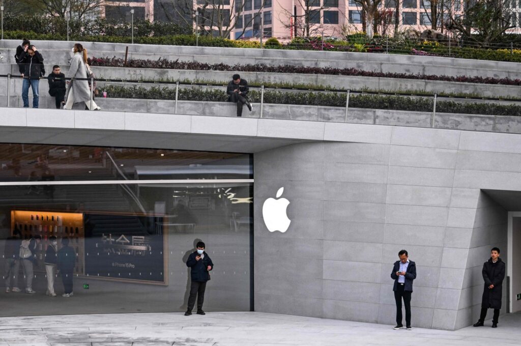 People stand outside a recently opened Apple Store in Shanghai's Jing'an district, China, March 26, 2024. (AFP Photo)