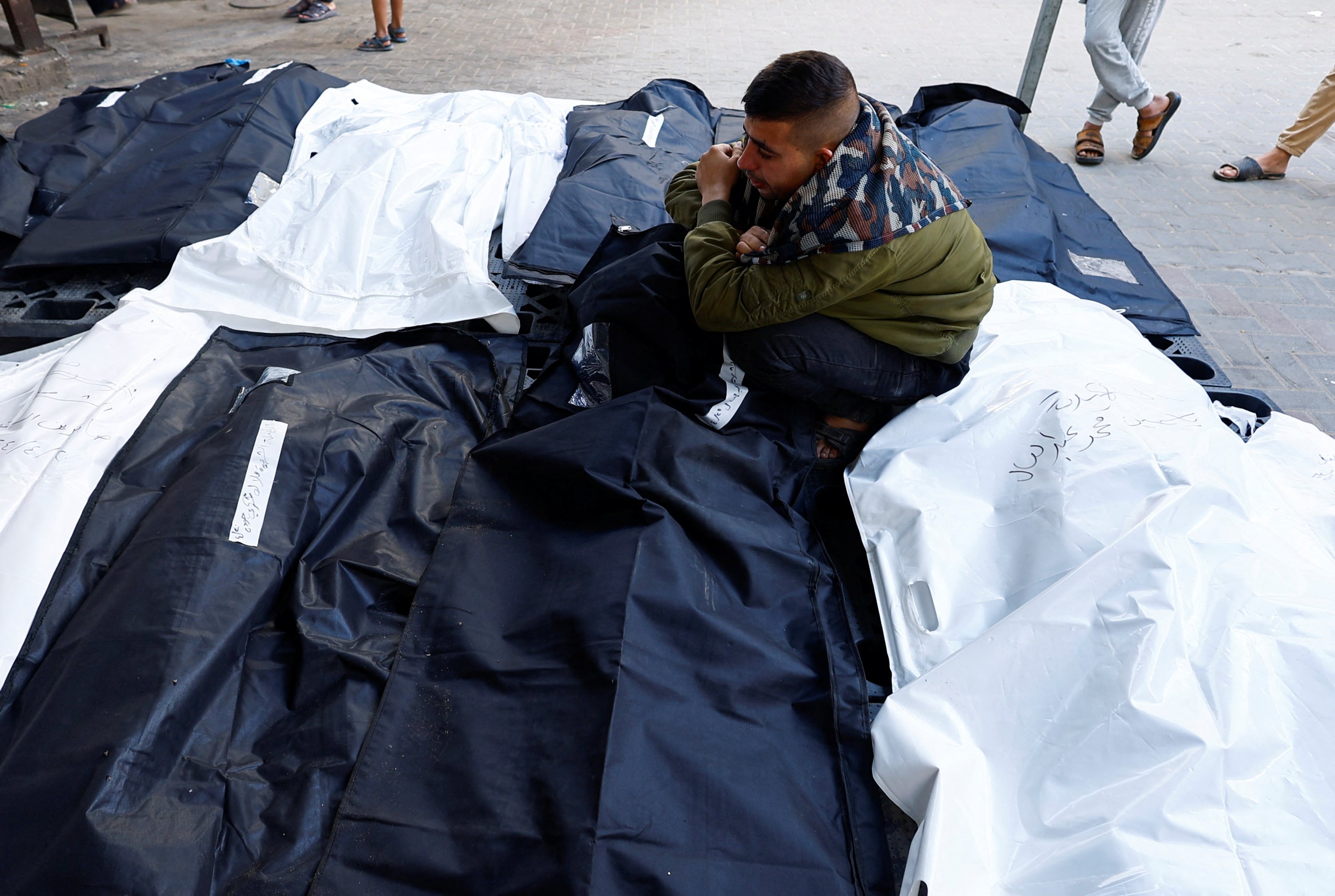 324435 A man mourns sitting amid bodies of Palestinians killed in strikes, amid the ongoing Israeli attacks on Gaza, Rafah, Palestine, April 21, 2024. (Reuters Photo)