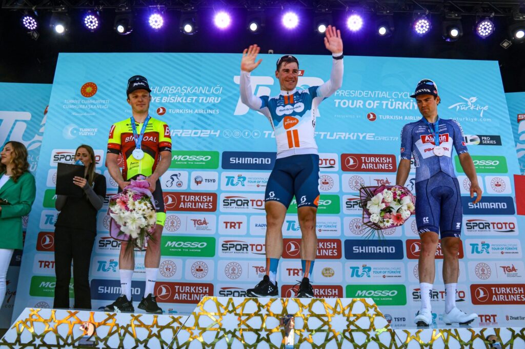 The 134.7-kilometer Antalya-Antalya stage of the Presidential Tour of Türkiye winner Fabio Jakobsen (C) celebrates at the podium, Antalya, Türkiye, April 21, 2024. (IHA Photo)