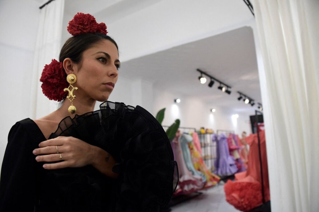 Customer Virginia Cuaresma tries on a flamenco dress at Luis Fernandez's workshop in Seville, Spain, April 8, 2024. (AFP Photo)