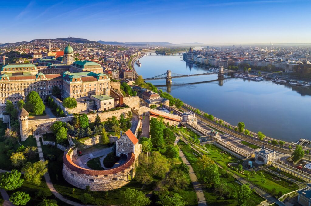 Aerial panoramic skyline view of Buda Castle Royal Palace with Szechenyi Chain Bridge. (Shutterstock Photo)