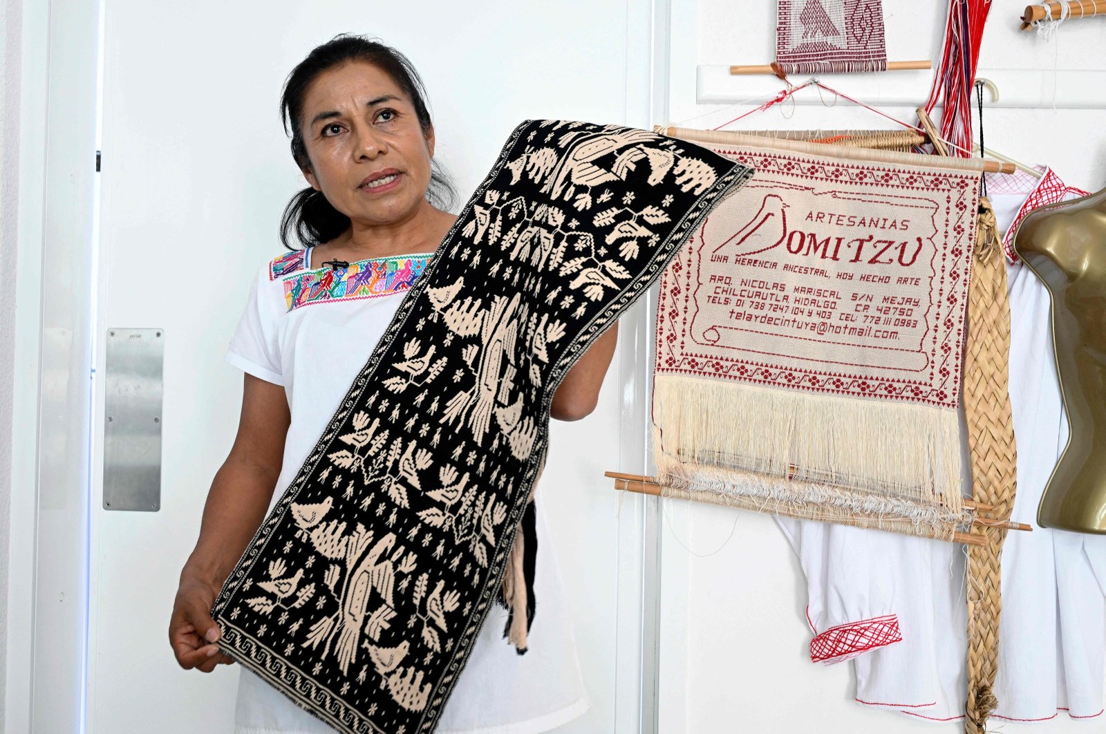 Hnahnu Indigenous woman Trinidad Gonzalez, from the Otomi area, explains the embroidery of the garment called "Quexquemeth" in the town of El Mejay in Hidalgo State, Mexico, April 10, 2024. (AFP Photo)