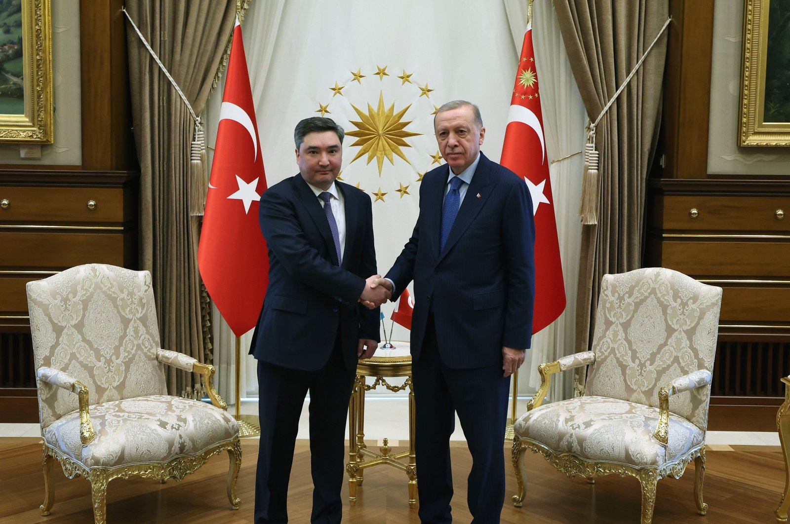 President Recep Tayyip Erdoğan and Kazakh Prime Minister Olzhas Bektenov shake hands in Türkiye's capital Ankara, April 25, 2024. (DHA Photo)