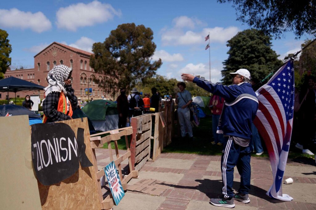 A pro-Palestinian demonstrator interacts with a pro-Israel demonstrator in an encampment on the campus of UCLA in Los Angeles, California, U.S., April 25, 2024. (AFP Photo)