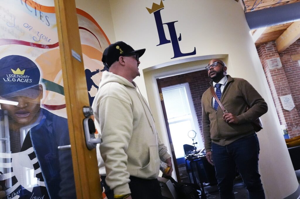 Ron Waddell, founder and executive director of Legendary Legacies, (R) talks with Gary Goyette at the nonprofit organization, Worcester, Mass., U.S., April 19, 2024. (AP Photo)