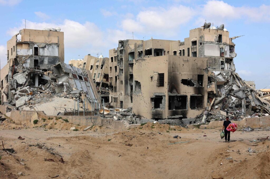 A Palestinian man carries belongings in Beit Lahya in the northern Gaza Strip on May 4, 2024. (AFP Photo)