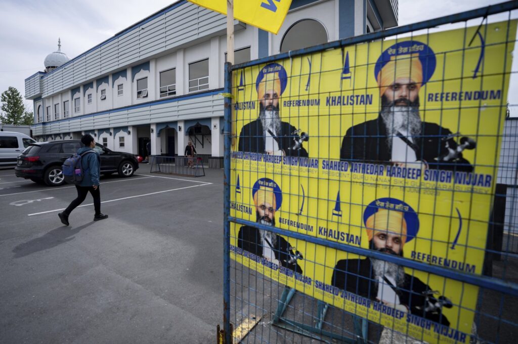 A person walks past signs of Hardeep Singh Nijjar at the Guru Nanak Sikh Gurdwara in Surrey, B.C., Canada, May 3, 2024. (AP Photo)