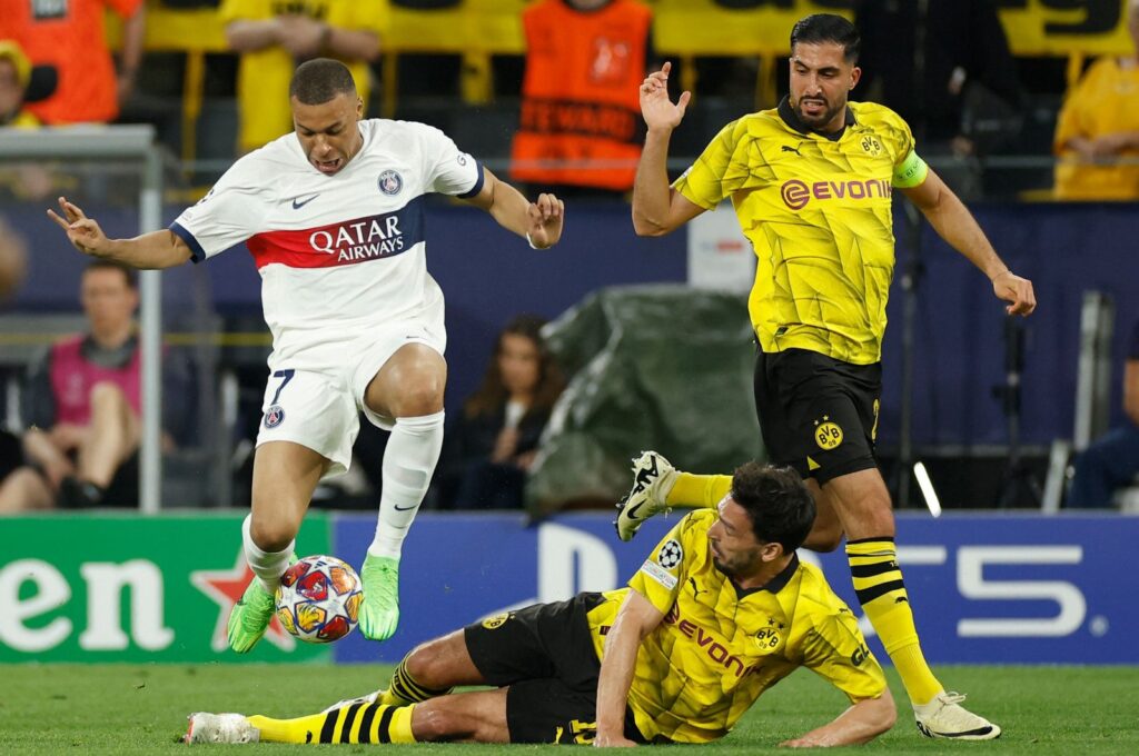 (L-R) Paris Saint-Germain's Kylian Mbappe, Dortmund's Mats Hummels and Emre Can vie for the ball during the UEFA Champions League semifinal first leg football match, Dortmund, Germany, May 1, 2024. (AFP Photo)
