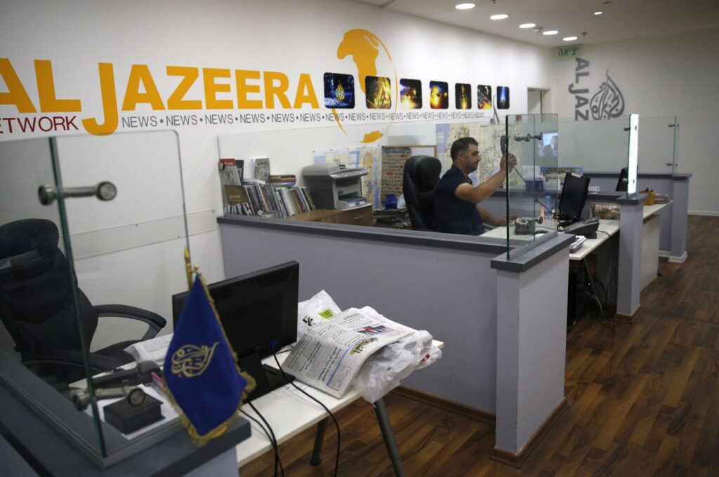 An employee of the Qatar-based news network and TV channel Al-Jazeera is seen at the channel's Jerusalem office, July 31, 2017. (AFP File Photo)