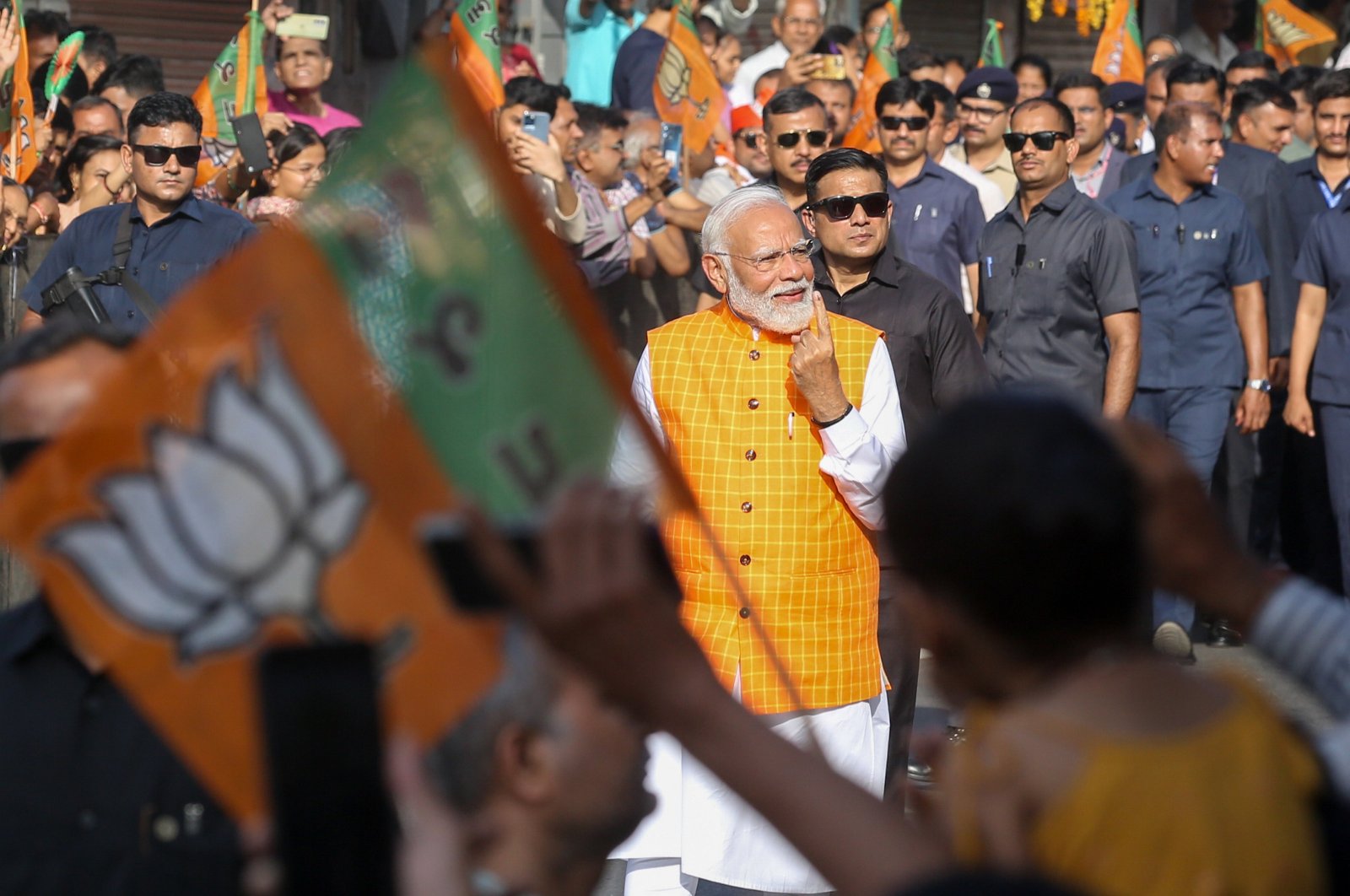 Indian Prime Minister Narendra Modi (C) shows his ink-marked finger after casting his vote for the third phase of general elections in Ahmedabad, Gujarat, western India, May 7, 2024. (EPA Photo)