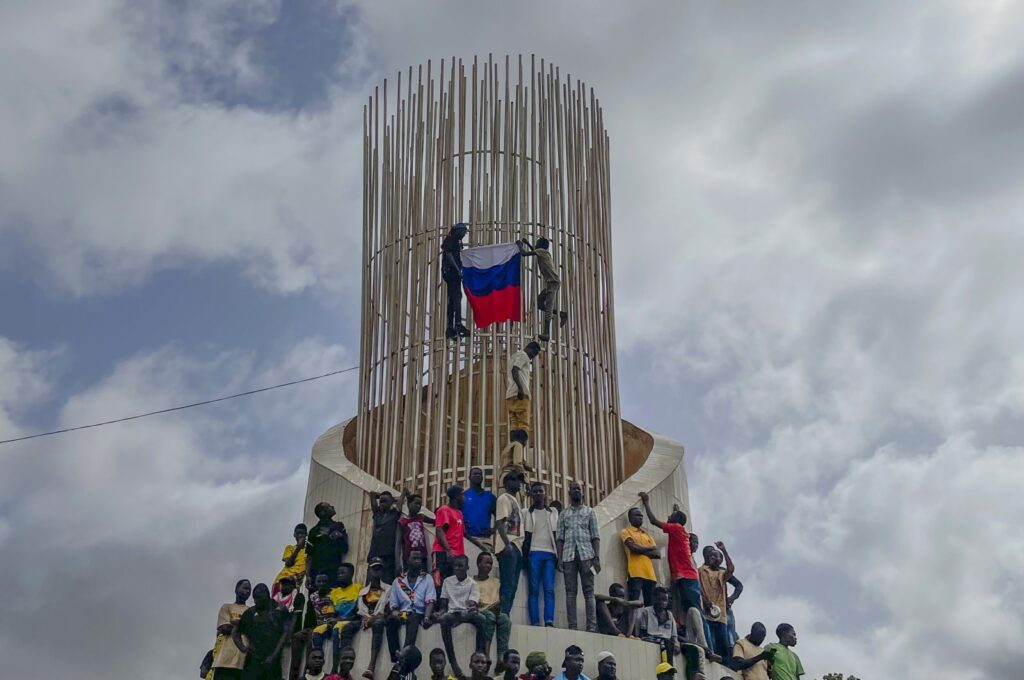 Supporters of Niger's ruling junta hold a Russian flag at the start of a protest called to fight for the country's freedom and push back against foreign interference in Niamey, Niger, Aug. 3, 2023. (AP Photo)