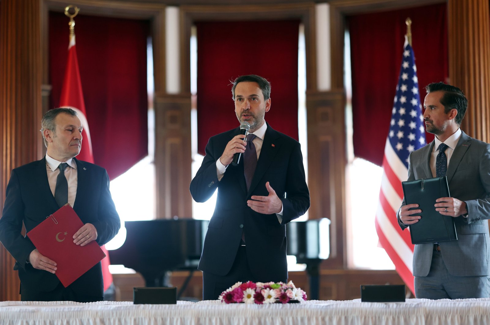 Energy and Natural Resources Minister Alparslan Bayraktar (C) delivers a speech during a signing ceremony on the LNG deal between BOTAŞ and ExxonMobil, Washington, United States, May 8, 2024. (AA Photo)