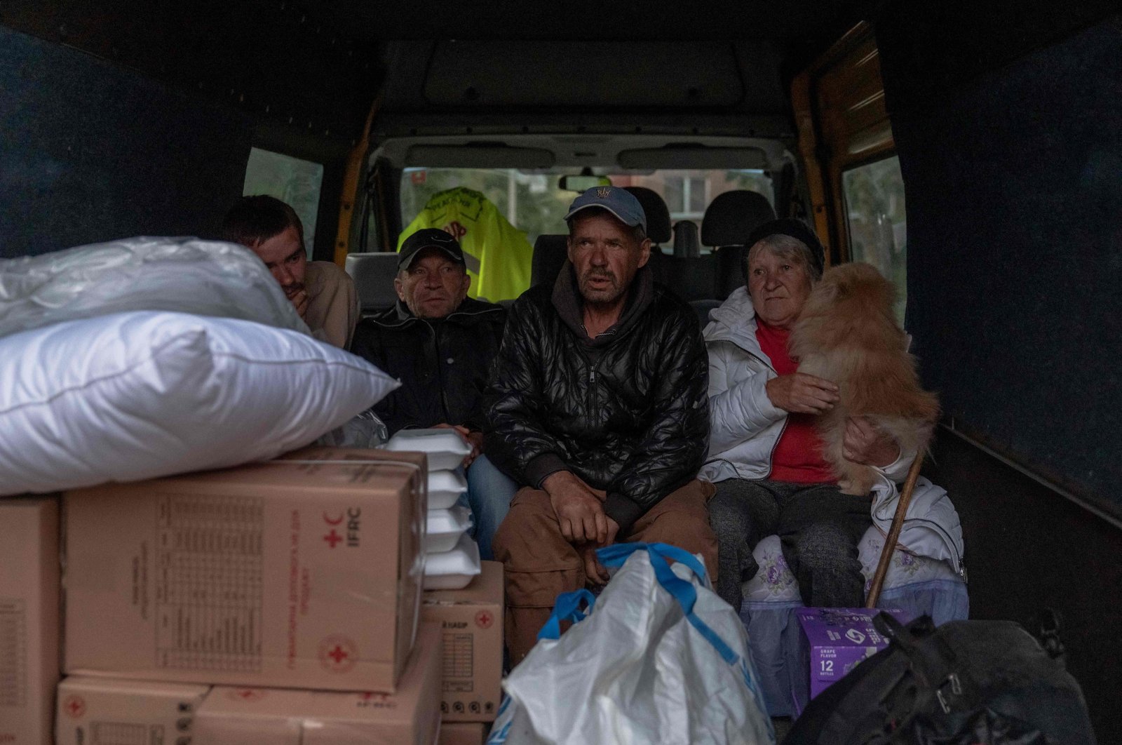Ukrainian evacuees from the village of Lyptsi wait in a minivan at an evacuation point in Kharkiv, May 11, 2024. (AFP Photo)