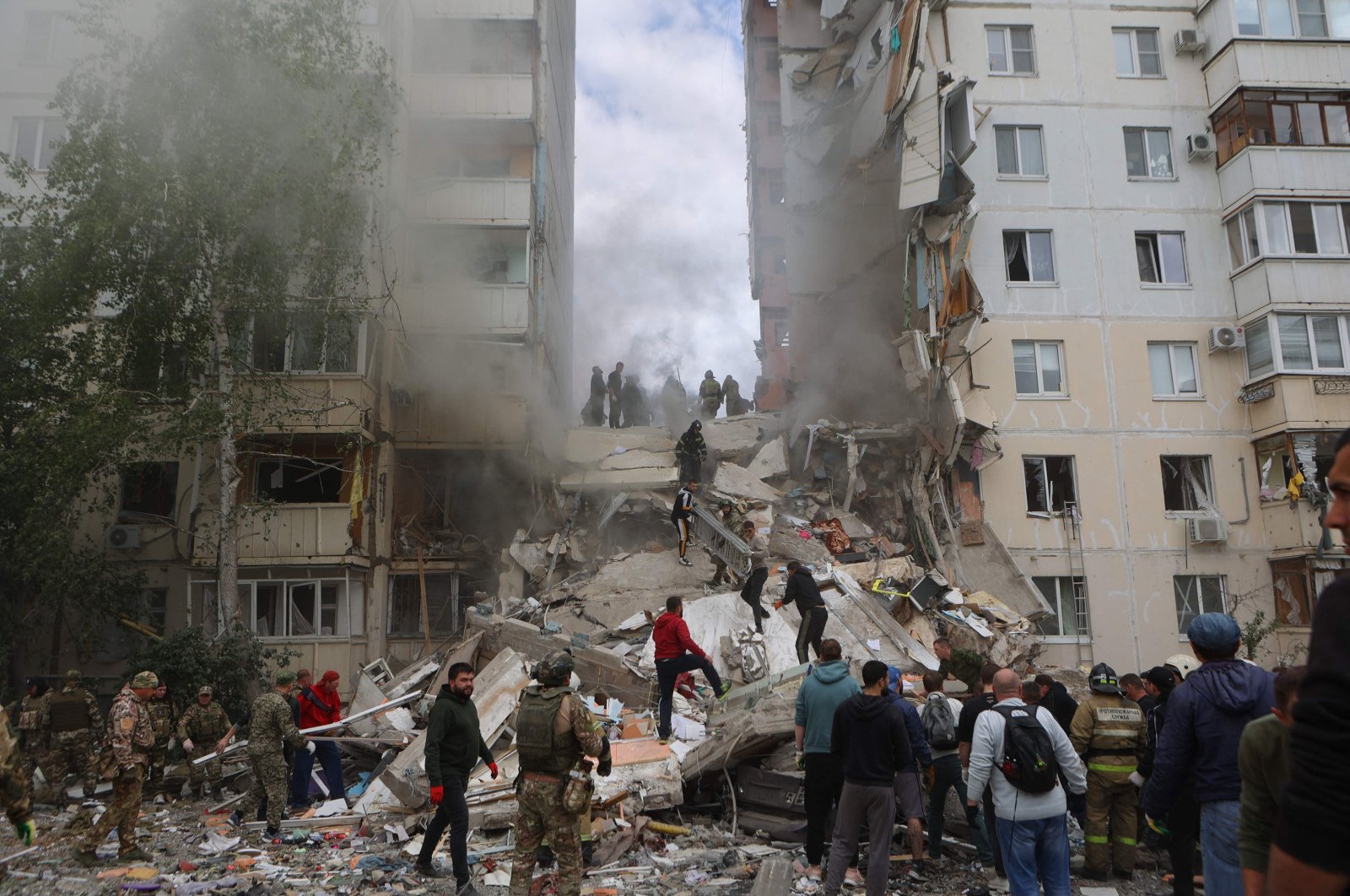 Russian firefighters and volunteers operate to secure the area on the site of a partially collapsed apartment building hit by a Ukrainian strike in Belgorod, Russia, May 12, 2024. (AFP Photo)