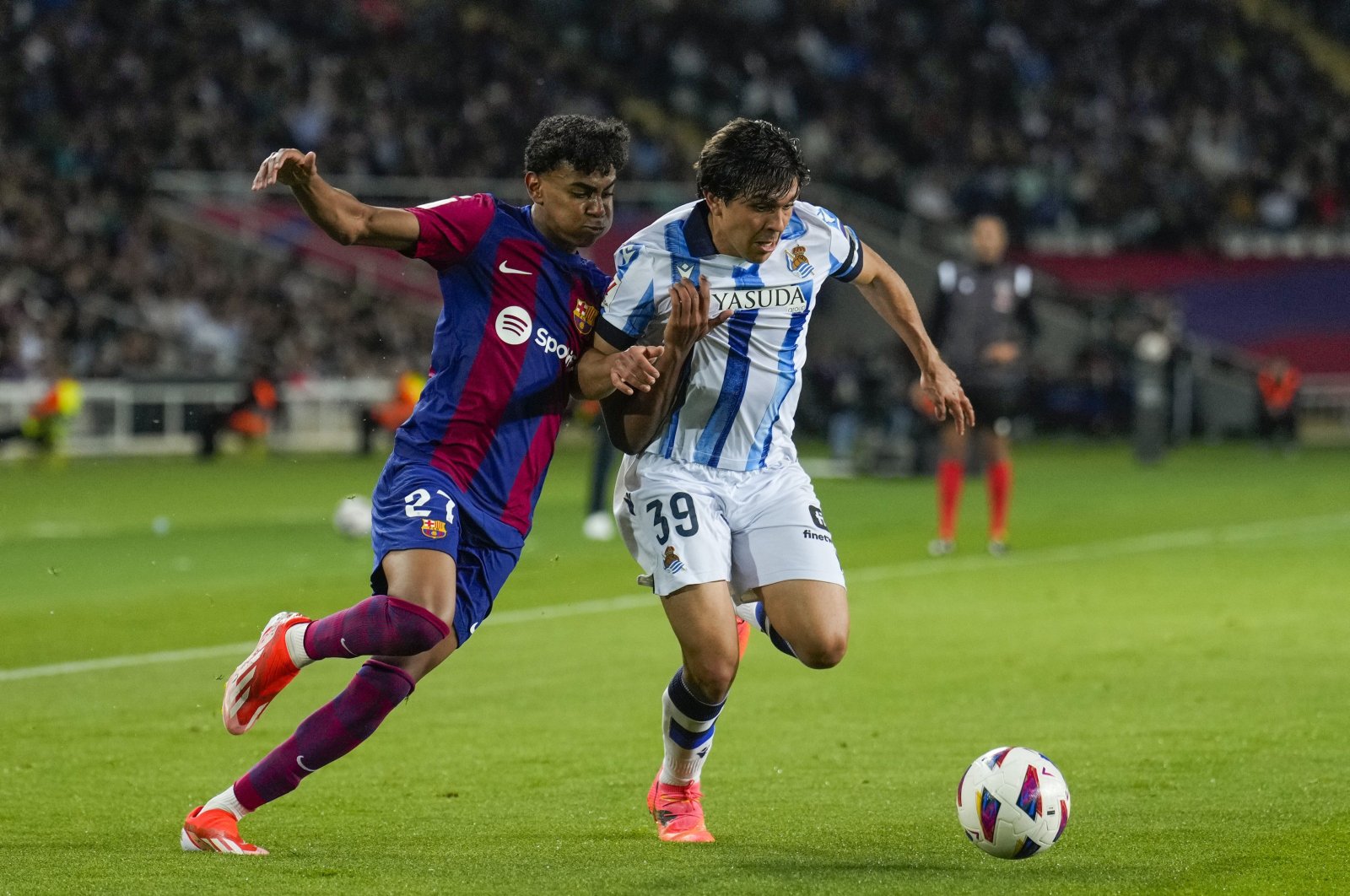 FC Barcelona's Lamine Yamal (L) in action against Real Sociedad's Jon Aramburu during the Spanish LaLiga match at Lluis Companys stadium in Barcelona, Spain, May 13, 2024. (EPA Photo)