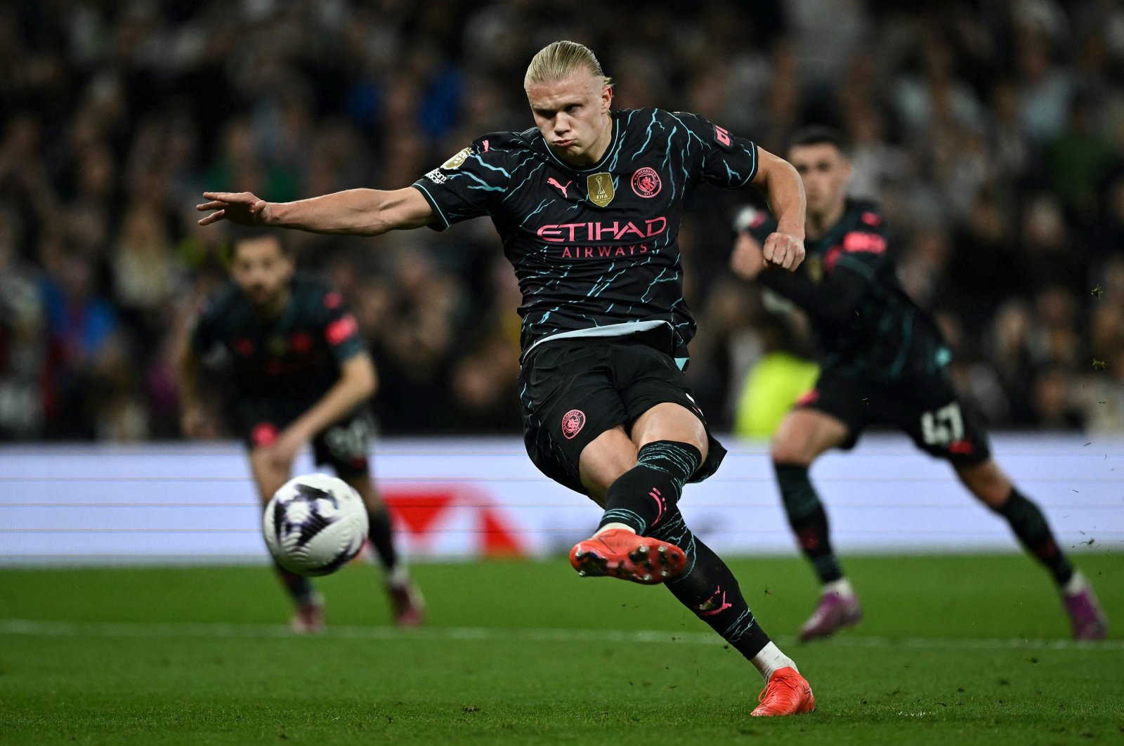 Manchester City's Erling Haaland shoots a penalty kick and scores his team's second goal during the English Premier League football match against Tottenham Hotspur at the Tottenham Hotspur Stadium in London, U.K., May 14, 2024. (AFP Photo)