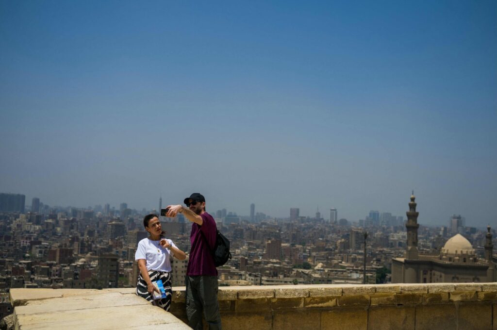 Visitors take photos with the city skyline at the Salaheddin Citadel, Cairo, Egypt, May 2, 2024. (AFP Photo)