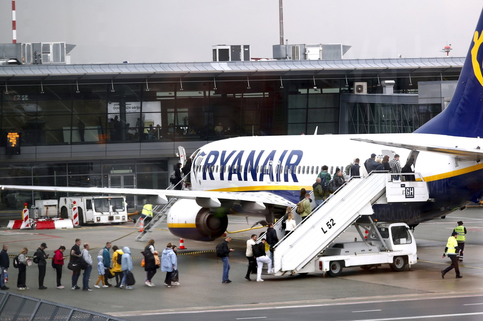 Passengers board a Ryanair group airplane at Riga Airport, Riga, Latvia, April 30, 2024. (EPA Photo)
