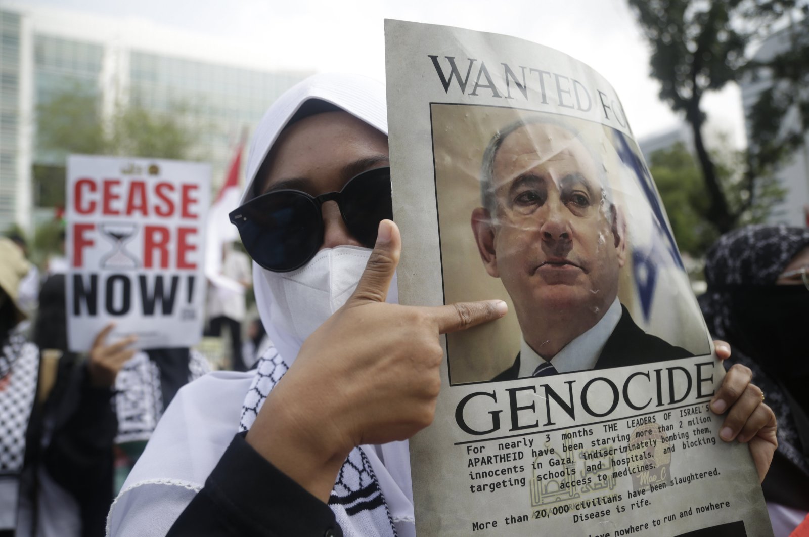 Indonesian activists hold a banner reading "ceasefire now" and a picture of Israeli leader Prime Minister Benjamin Netanyahu reading "wanted for genocide" as they stage a protest in Jakarta, Indonesia, May 17, 2024. (EPA Photo)