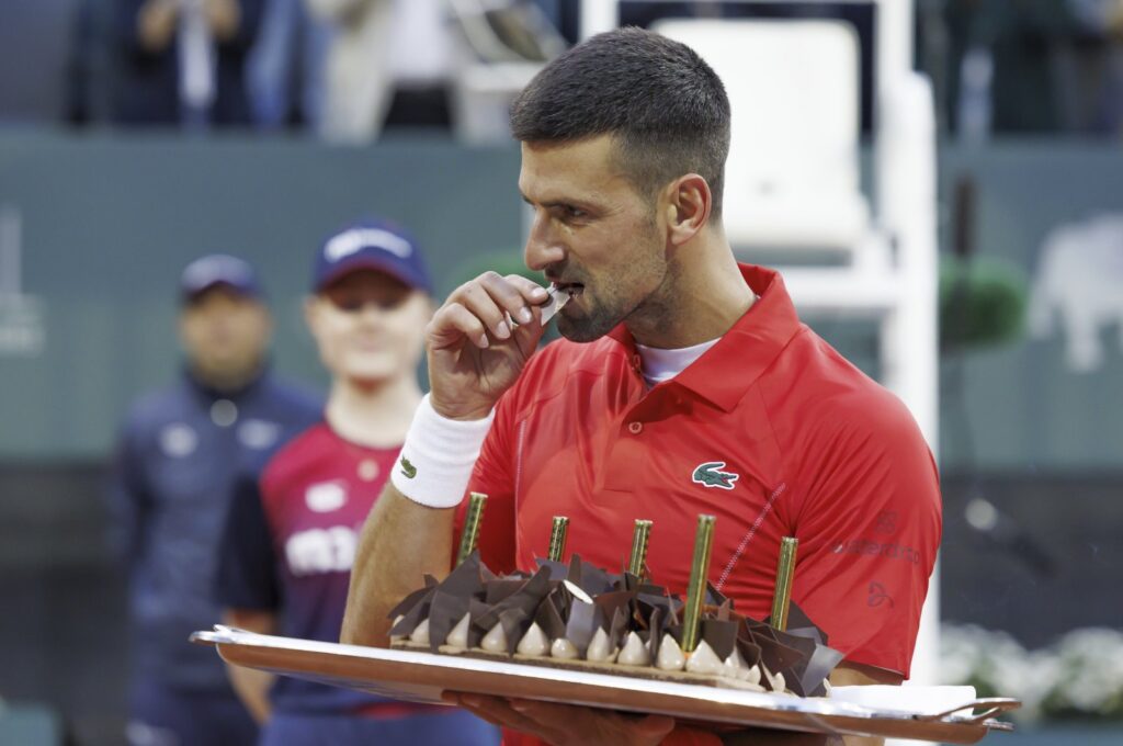 Serbia's Novak Djokovic tastes his birthday cake after he won his second round match of the ATP 250 Geneva Open tennis tournament against Germany's Yannick Hanfmann, Geneva, Switzerland, May 22, 2024. (AP Photo)