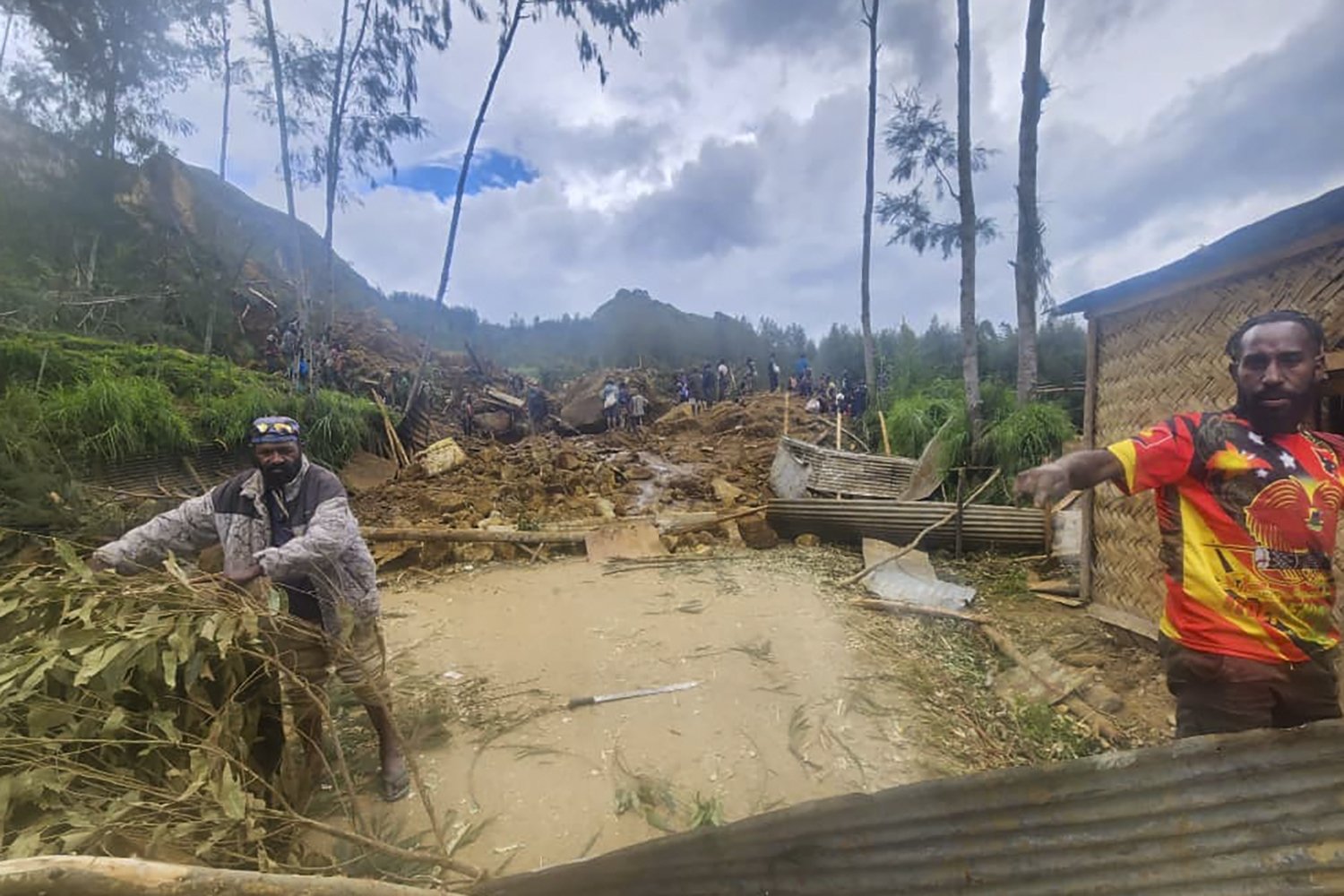 Villagers search through a landslide in Yambali in the Highlands of Papua New Guinea, May 26, 2024. (AP Photo)