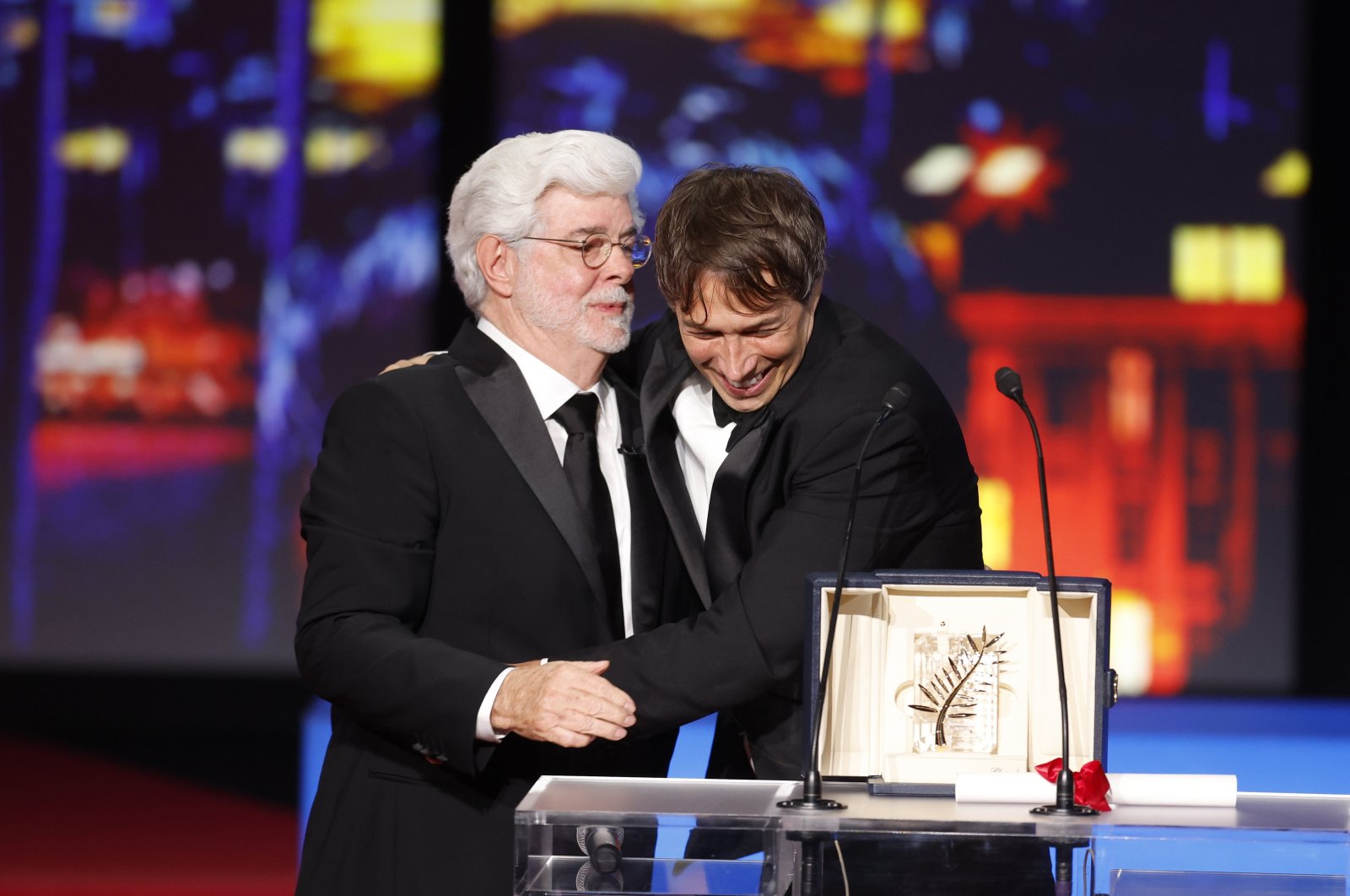 Sean Baker (R) receives the Palme D'Or Award for "Anora" from George Lucas (L) during the closing and awards ceremony of the 77th annual Cannes Film Festival, Cannes, France, May 25, 2024. (EPA Photo)