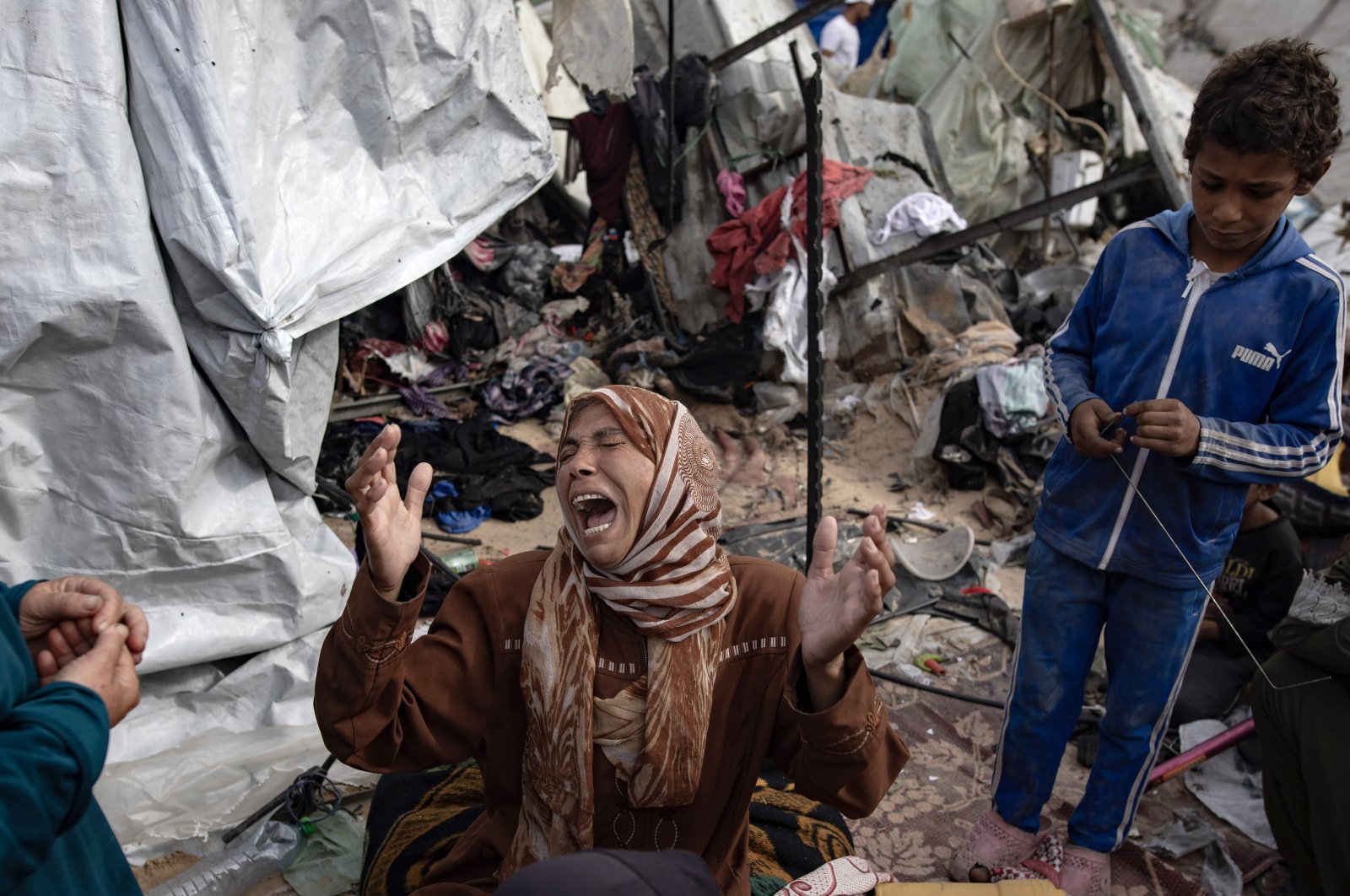 A woman reacts as Palestinians inspect the aftermath of Israel's airstrike on a tent camp in an area previously designated by the Israeli army as safe for displaced Palestinians, Rafah, southern Gaza Strip, Palestine, May 28, 2024. (EPA Photo)
