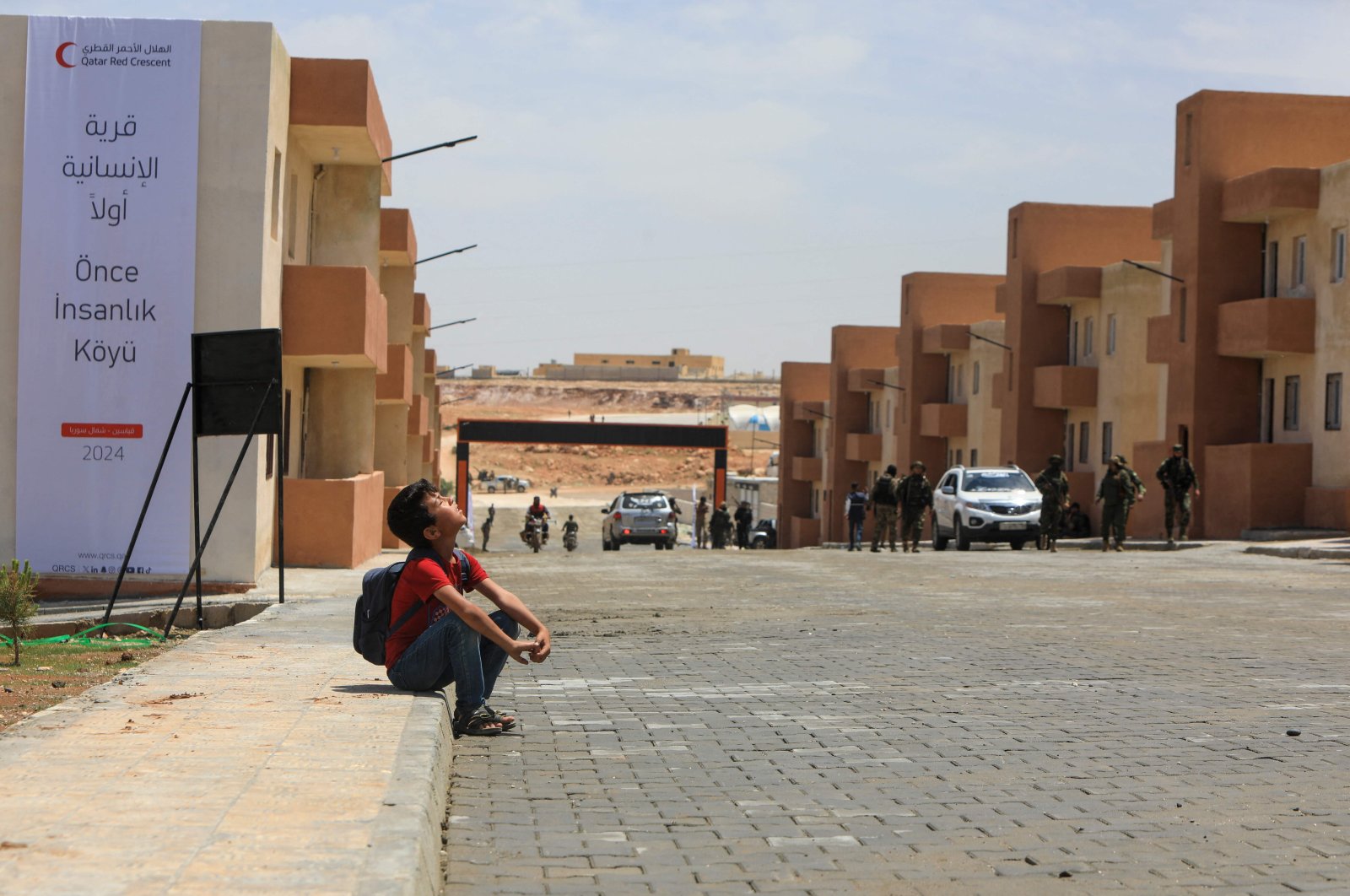 A child looks on at a block of newly constructed homes for displaced people near the town of Qabasin, northeast of al-Bab, some 30 kilometers from Aleppo, Syria, May 28, 2024. (AFP Photo)