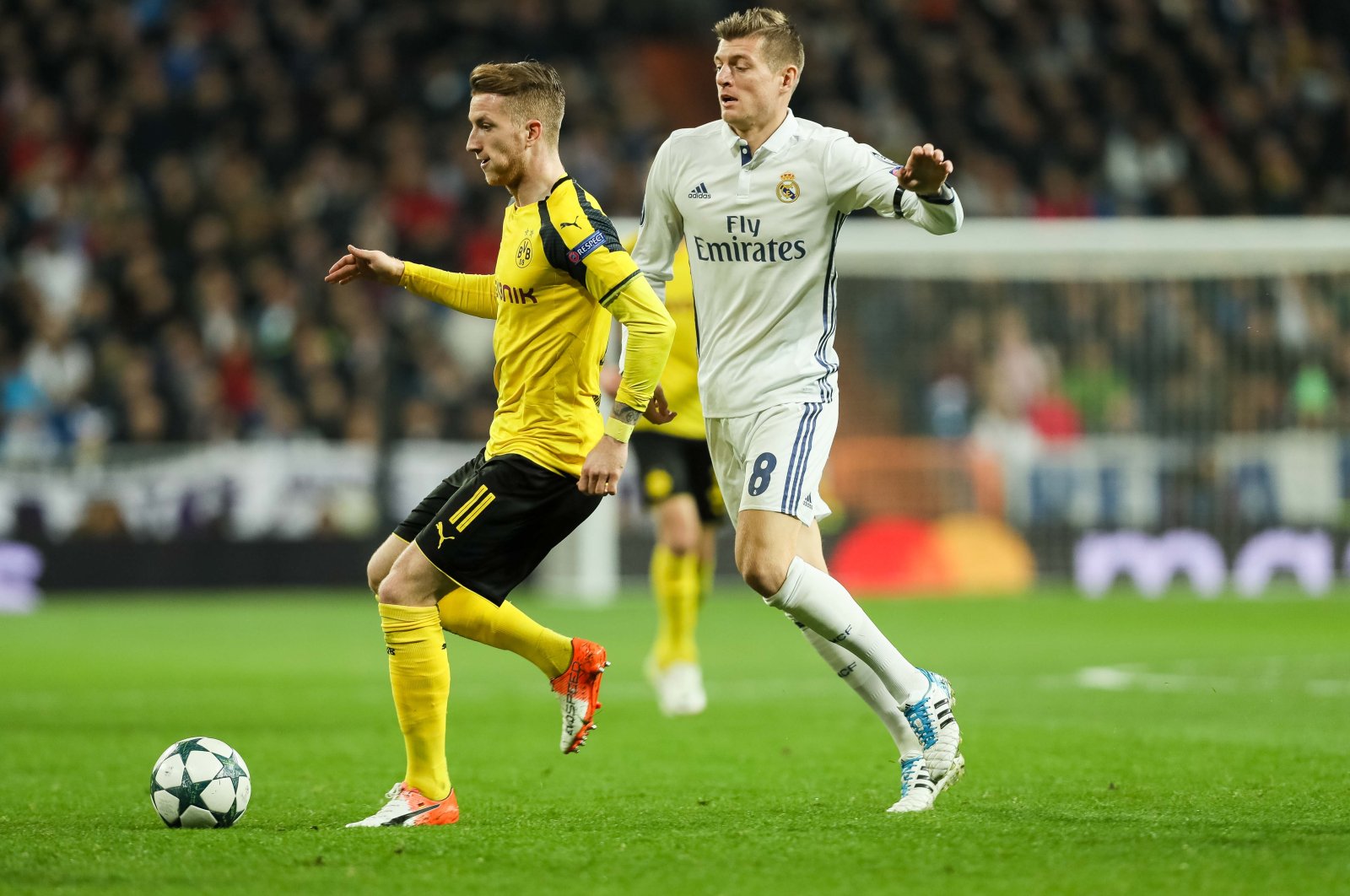 Borussia Dortmund's Marco Reus (L) and Real Madrid's Toni Kroos battle for the ball  during the UEFA Champions League match at the Santiago Bernabeu, Madrid, Spain, Dec. 7, 2016. (Getty Images Photo)