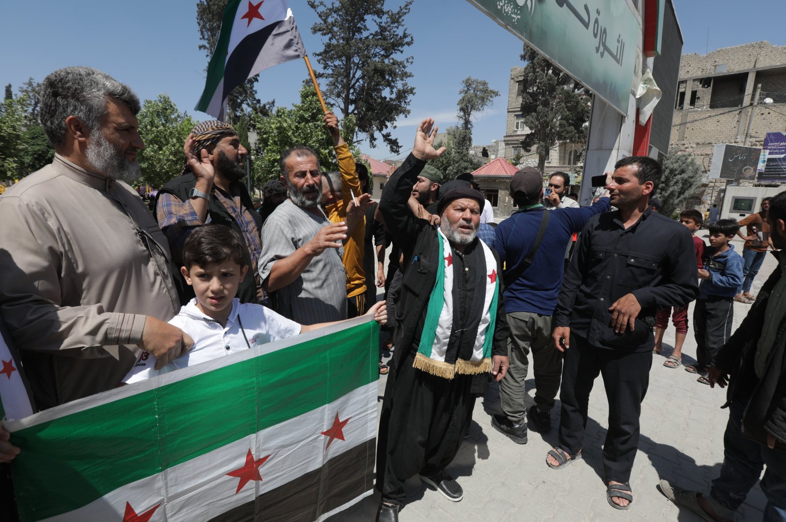 Protesters hold a flag of the Syrian opposition as they condemn the PKK/YPG terrorists' planned "elections" in northern Syria, May 31, 2024. (AA Photo)