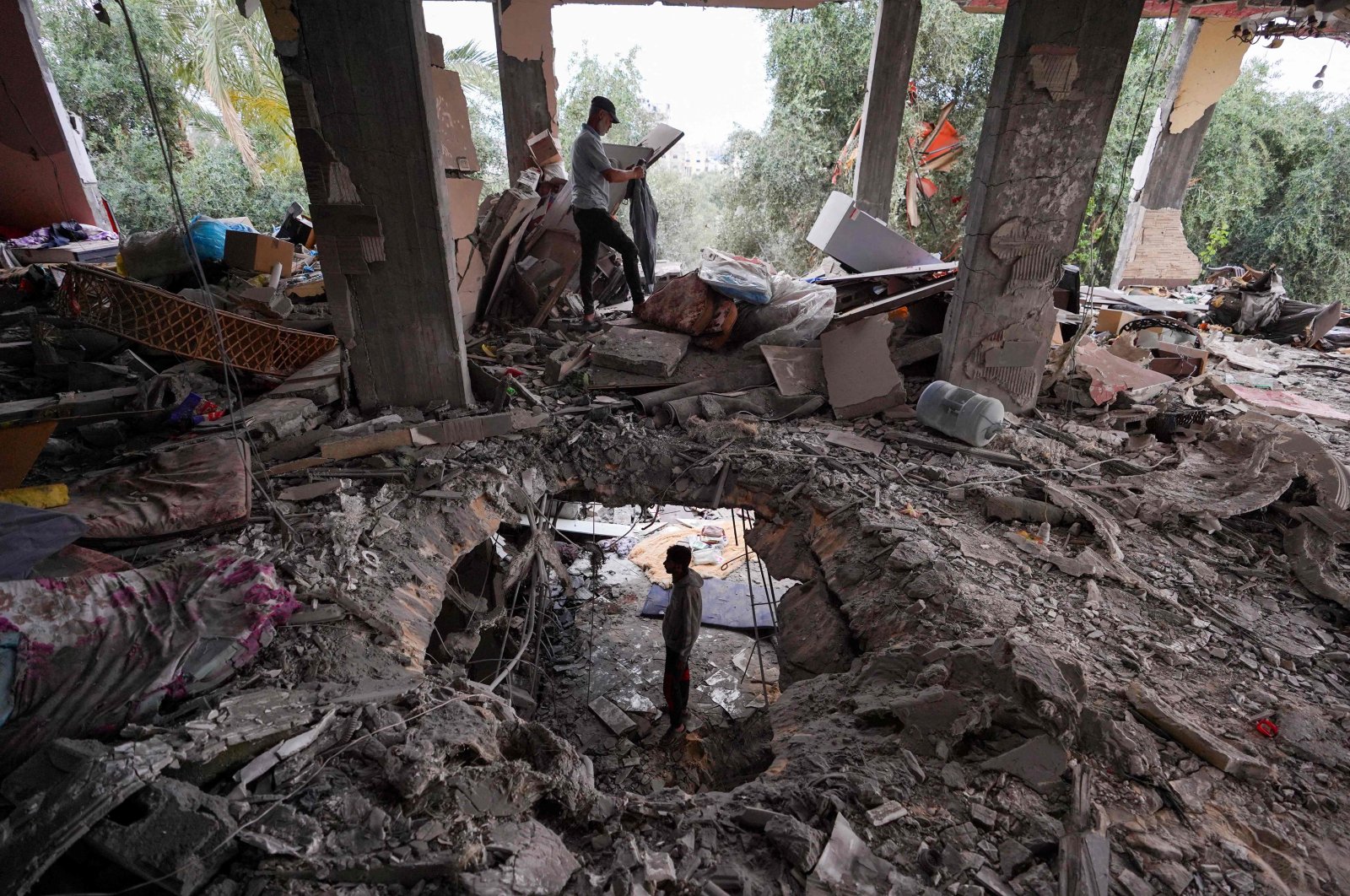 Palestinians inspect the damage to a house after it was hit in an Israeli strike in al-Bureij camp in the central Gaza Strip, Palestine, June 3, 2024. (AFP Photo)